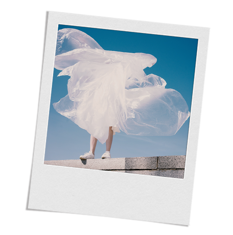 Image of person holding a giant sheet of plastic to represent the Waste page on alliblairnewyork.com.