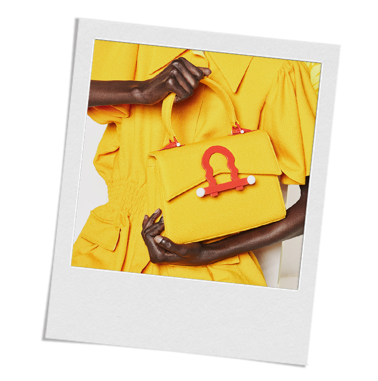 Image of ABNY model holding a ABNY purse to represent the Care page on alliblairnewyork.com.